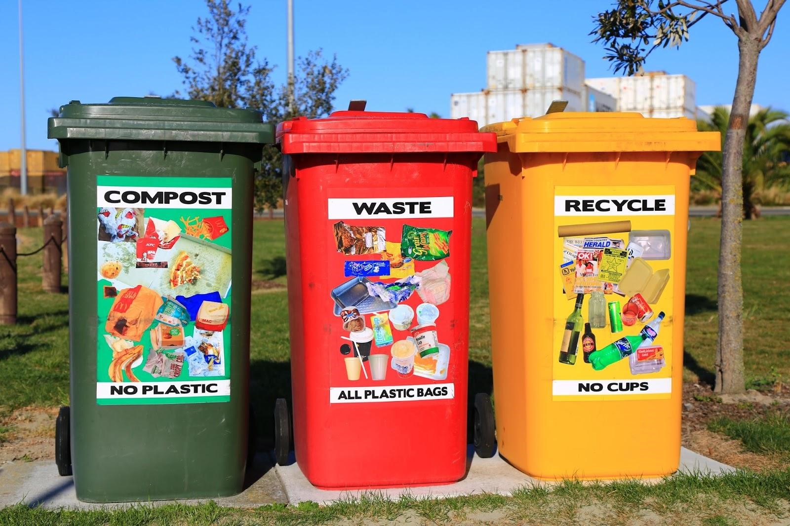 Three bins dedicated for compost - no plastic, waste - all plastic bags, and recycle - no cups, located in a public place