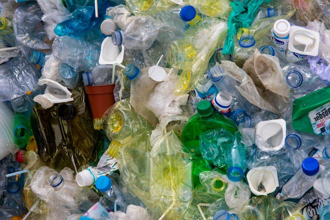pile of discarded plastic bottles and containers illustrating environmental pollution and waste management issues