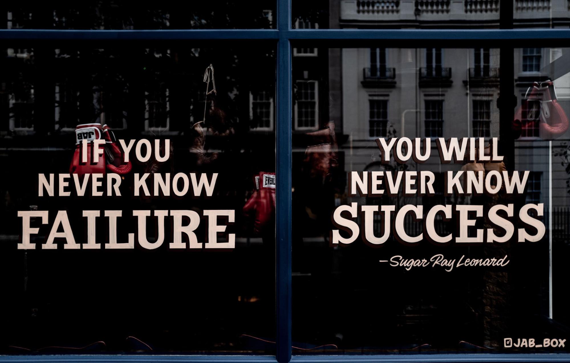 Boxing gym’s window display with “If you never know failure, you will never know defeat,” by Sugar Ray Leonard 
