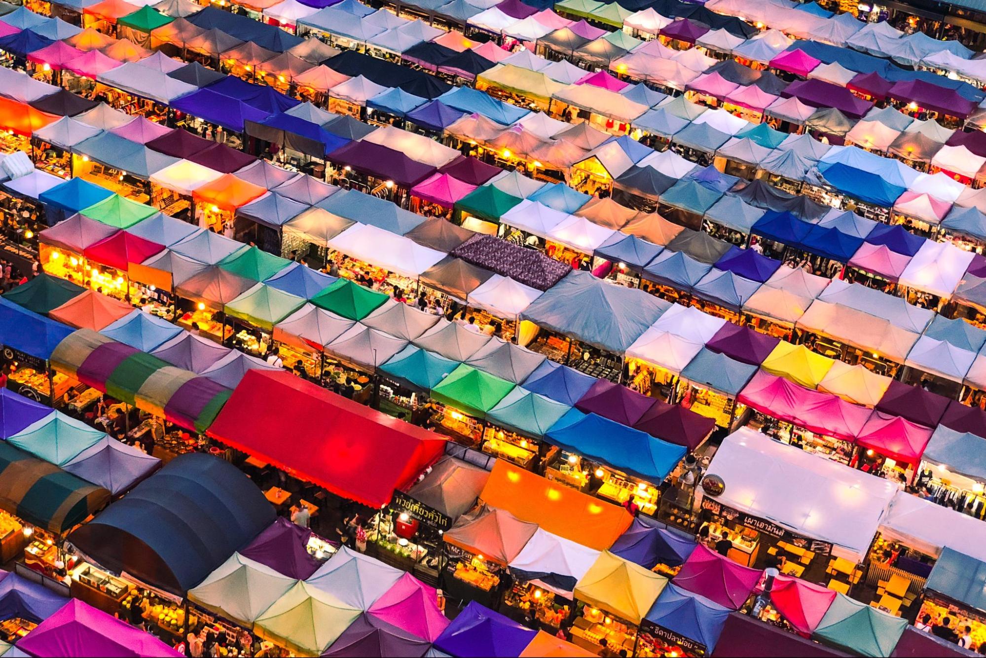 Aerial view of colorful market stalls selling variety of wares in Thailand